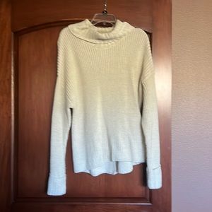 Cowl neck cream sweater with cuffs and tie detail on the back